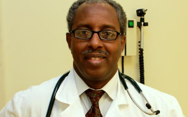 Dr. Mohamud Afgarshe in lab coat with stethoscope around his neck