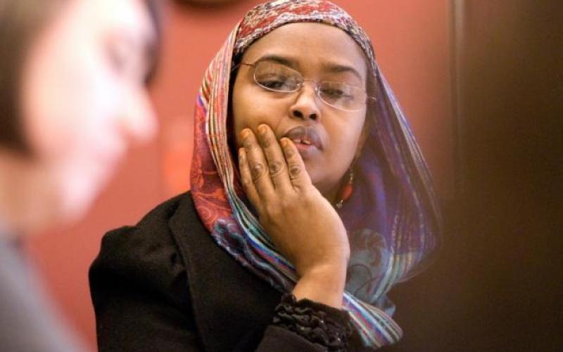 A woman wearing a hijab looks pensive