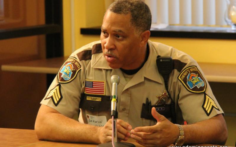 A Hennepin County Sherrif's Department Sergeant Derwin Ellis speaks to group