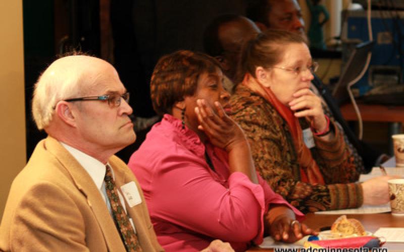 Participants listen at the round table