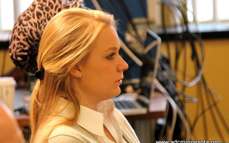 A participant listens to others at the roundtable