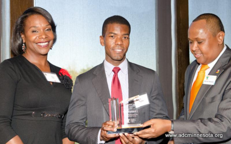 An awards recipient stands with Hussein Samatar