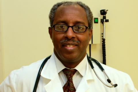 Dr. Mohamud Afgarshe in lab coat with stethoscope around his neck