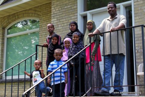 Somali family outside their newly-purchased home in St. Cloud, MN