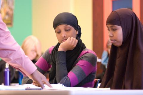 African women wearing Hijab study information about financial education